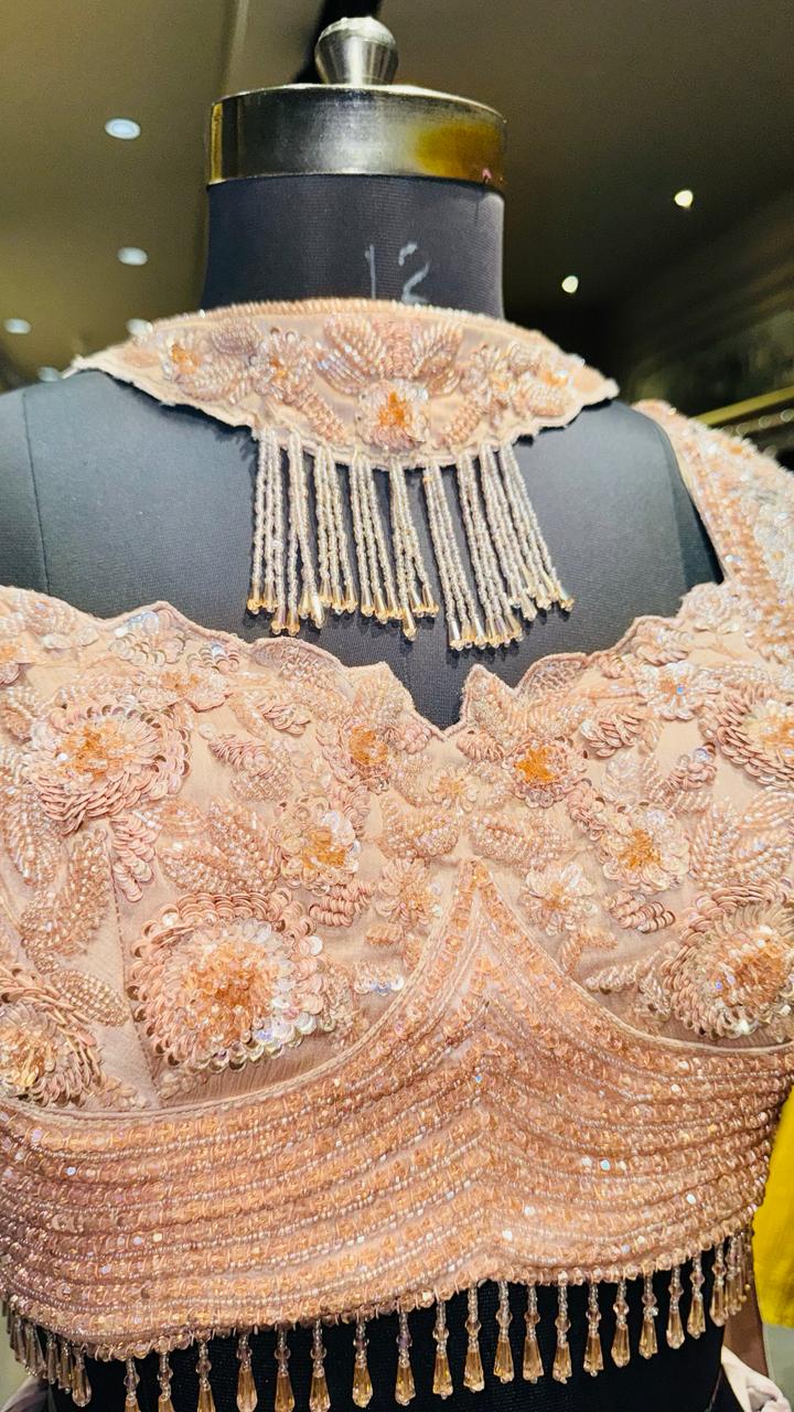Designer Rose Gold Fishcut Lehenga with Ruched Chevron Detailing and Pearl-Fringe Choker Bustier