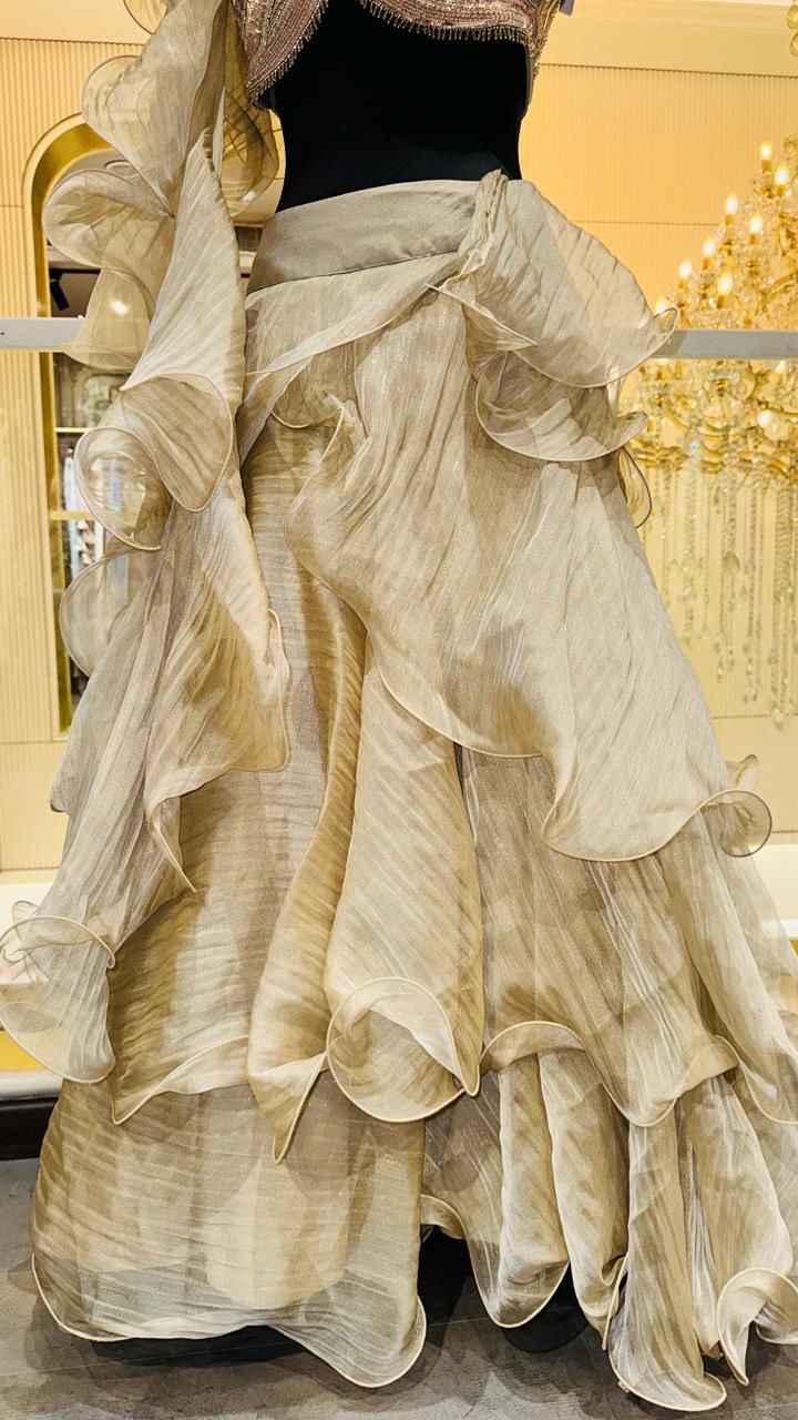 Designer Champagne Gold Ruffled Lehenga with Criss-Cross Strappy Bustier and Attached Organza Trailing Drape