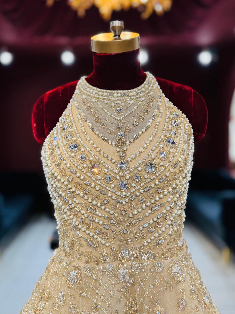 Premium Champagne Halter-Neck Gown with Heavy Pearl and Zari Embellishments