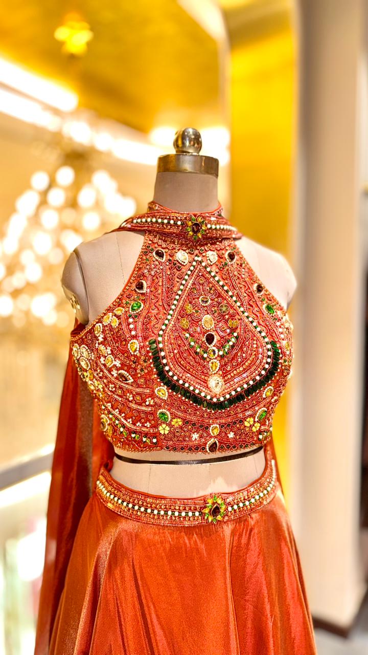 Rust-Orange Lehenga with Heavily Embellished Halter-Neck Blouse