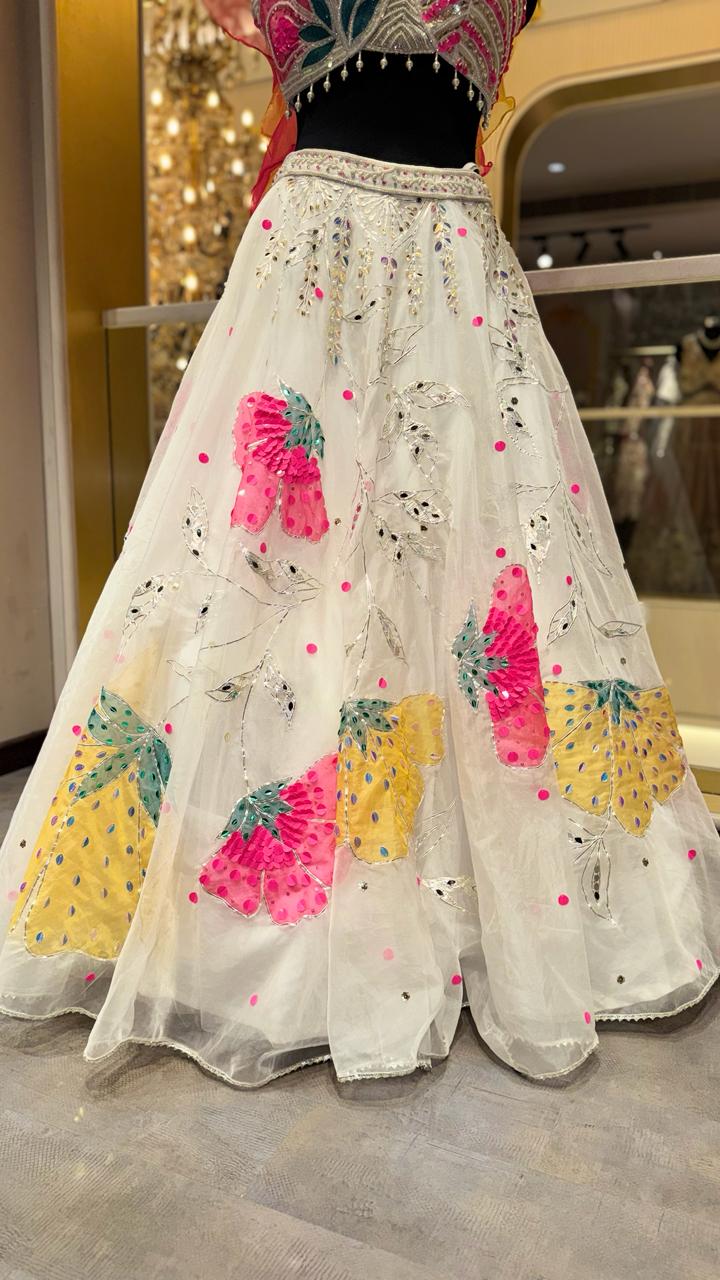 Designer Ivory Organza Lehenga with Candy Pink & Yellow 3D Appliqué and Ruffled Cape Sleeves